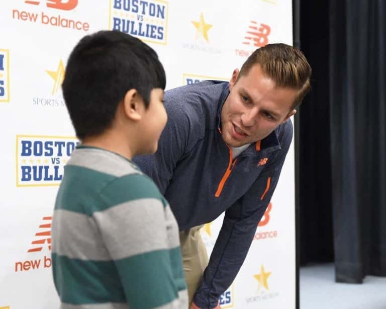 Justin Turri leaning down and speaking with a child